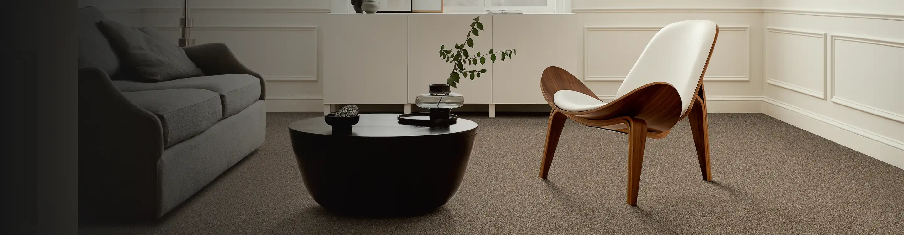 beige carpet in a sitting area with a wooden accent chair