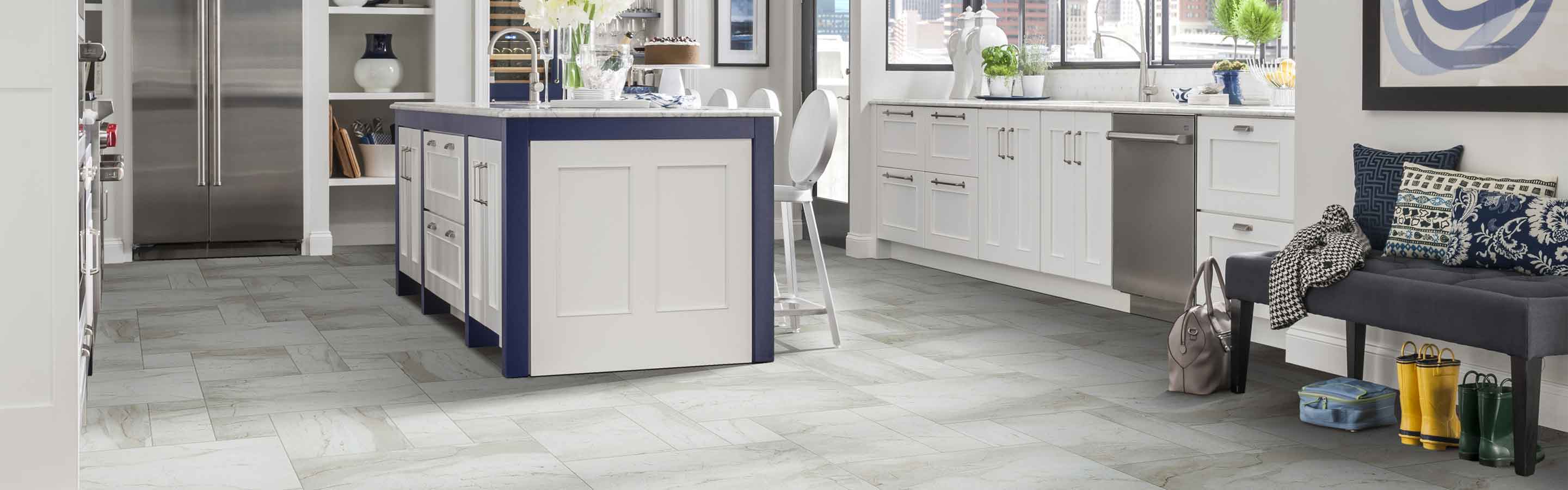 Kitchen with gray tile flooring and white cabinets